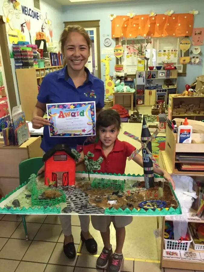 Teacher and student with a class award