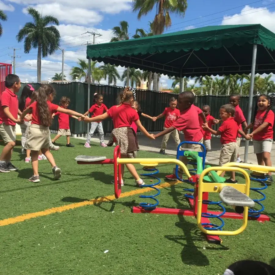 Tiny Tykes children playing a circle game on the playground